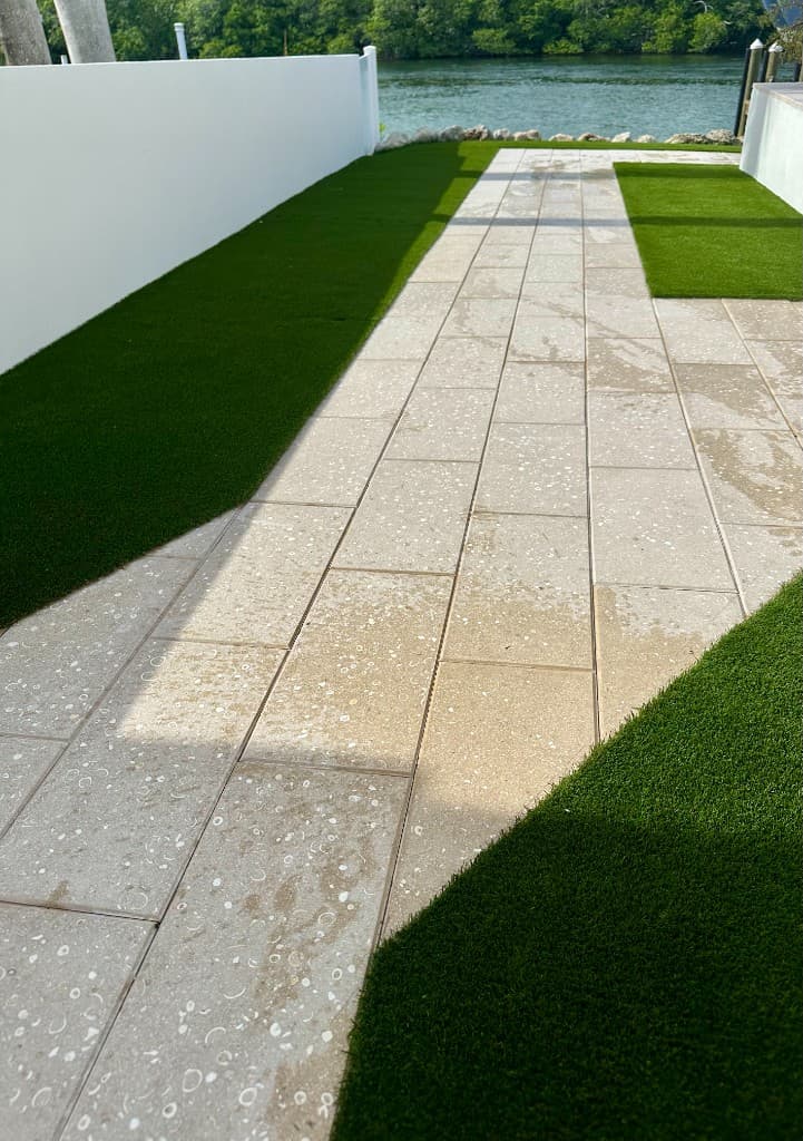 Artificial turf and paver walkway after Paradise Poo Rescue turf yard deodorizing service in the Florida Keys